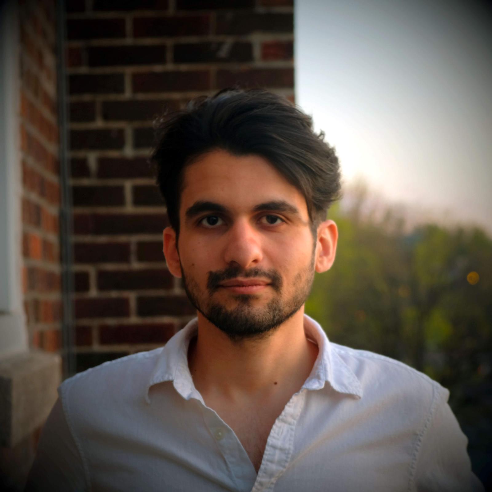 Payraw at golden hour, in front of a brick wall.